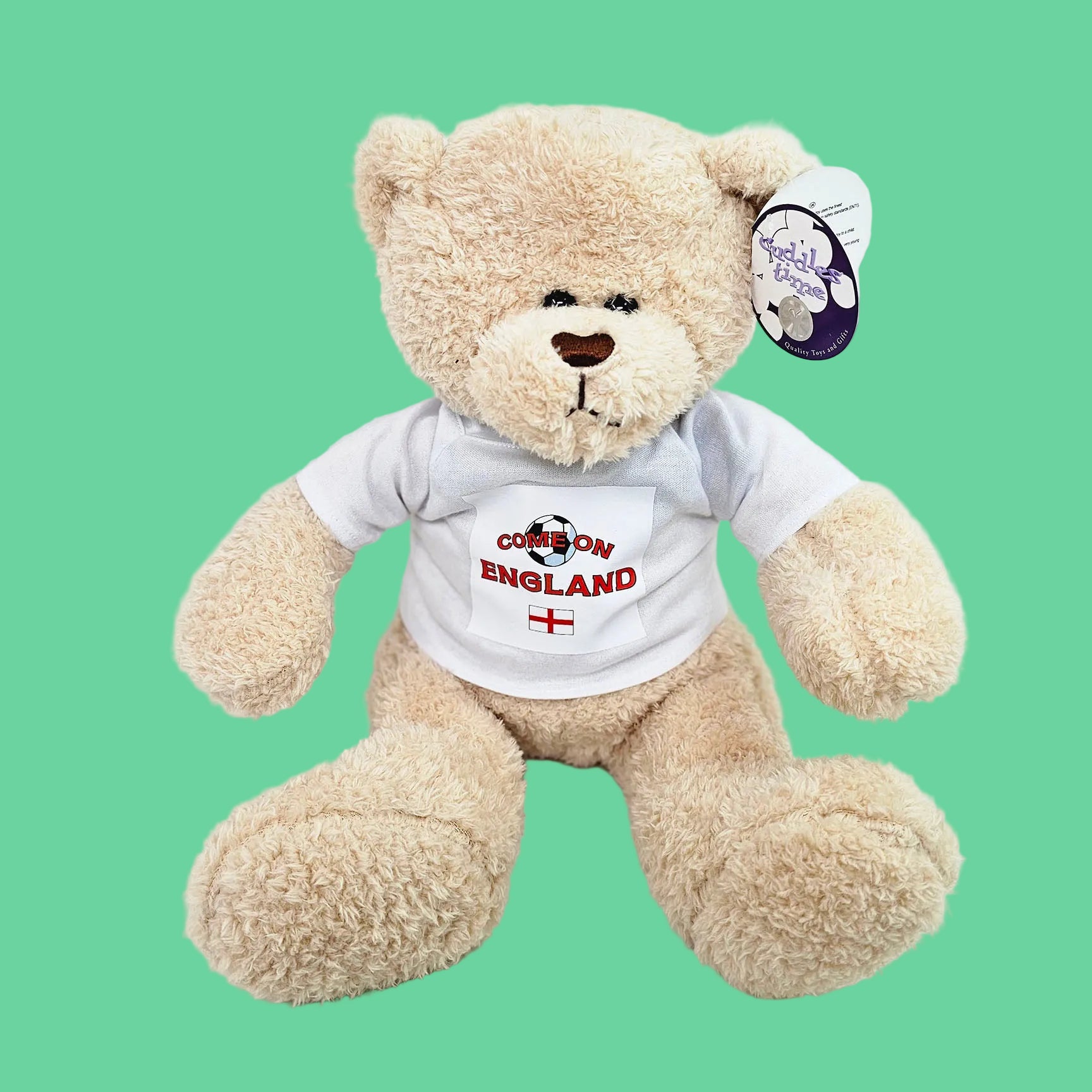 Beige teddy bear wearing a white t-shirt with 'Cheer on England' text and a red cross on a white background.