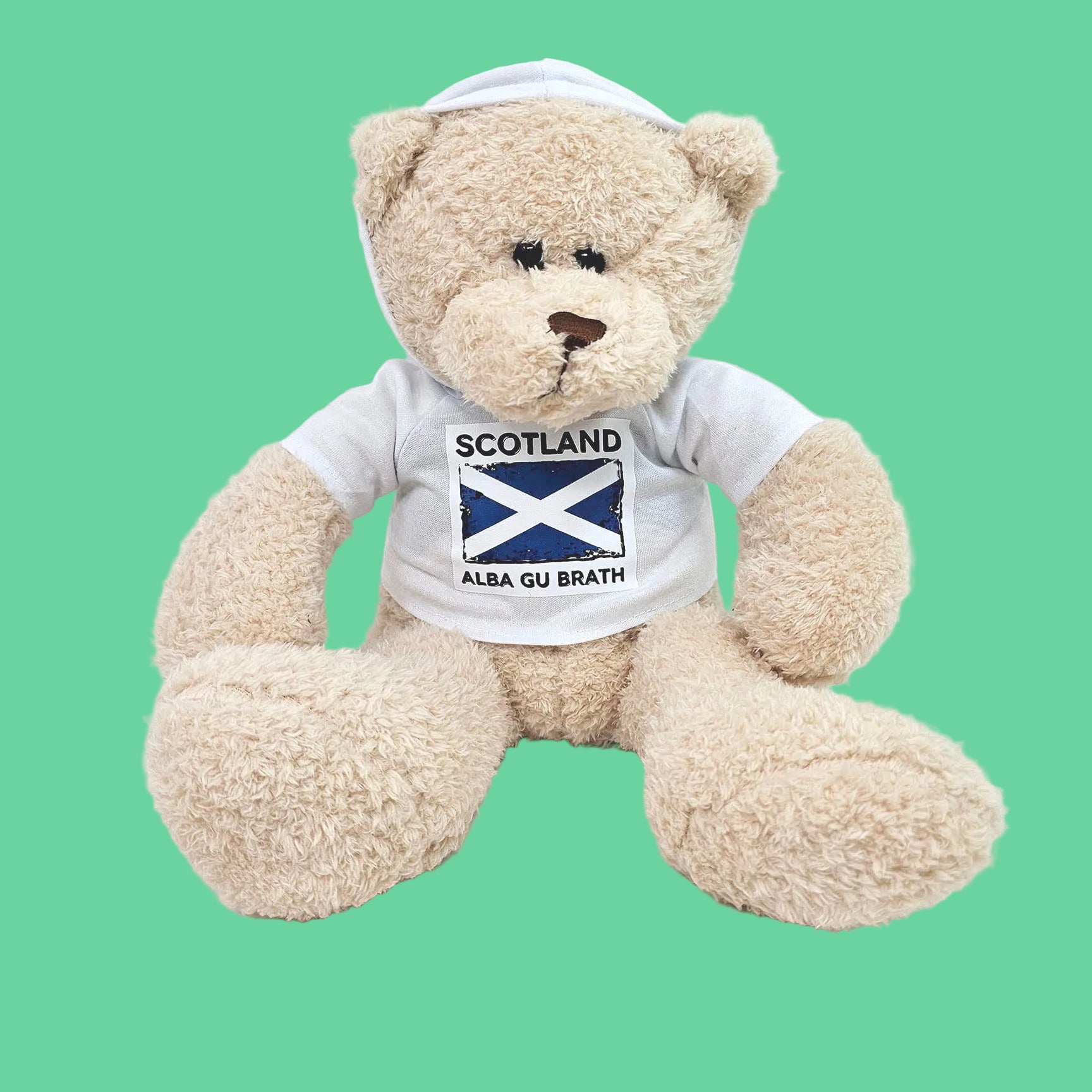 Teddy bear wearing a shirt with Scottish flag and text on a white background
