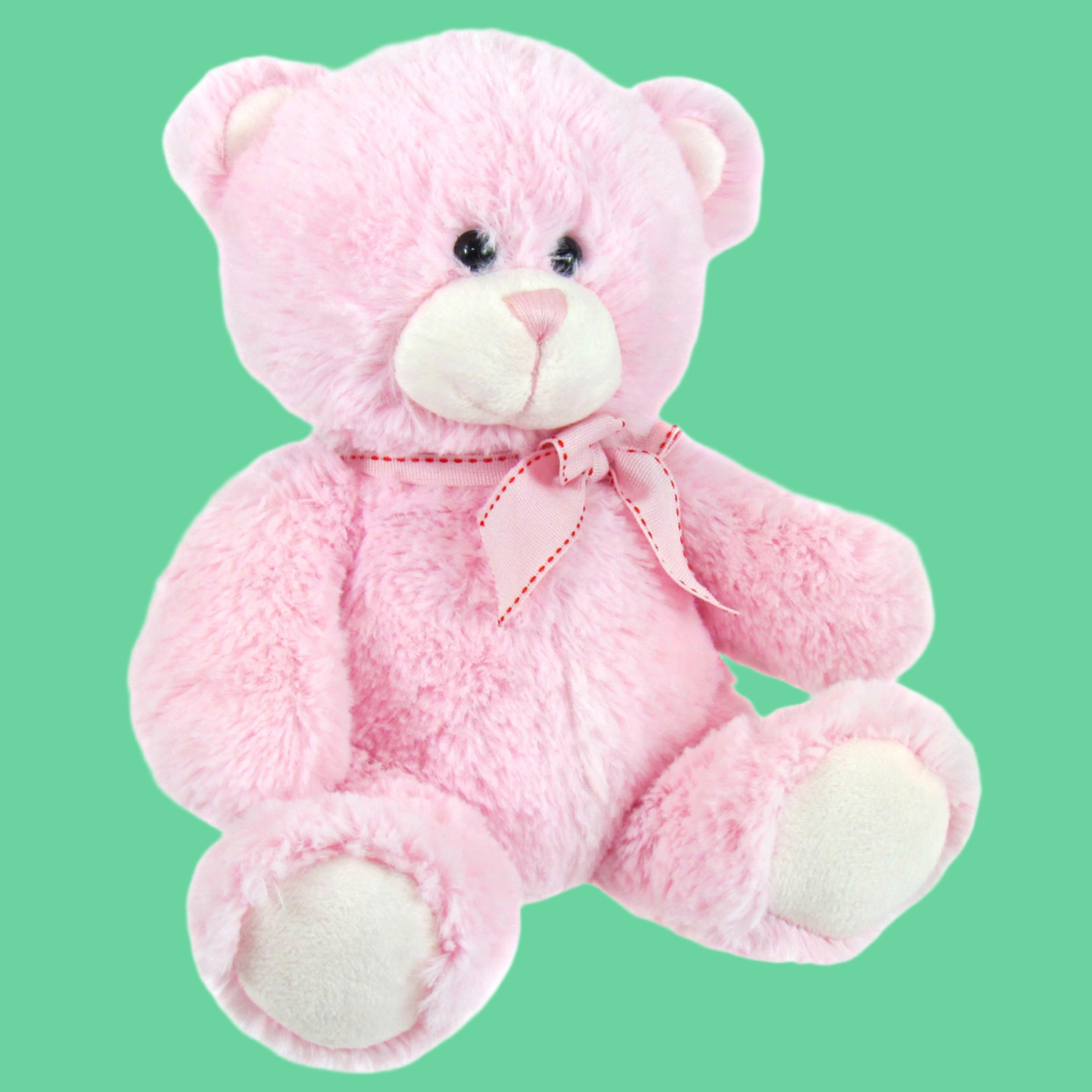 A small pink plush bear with a bow ribbon around its neck.