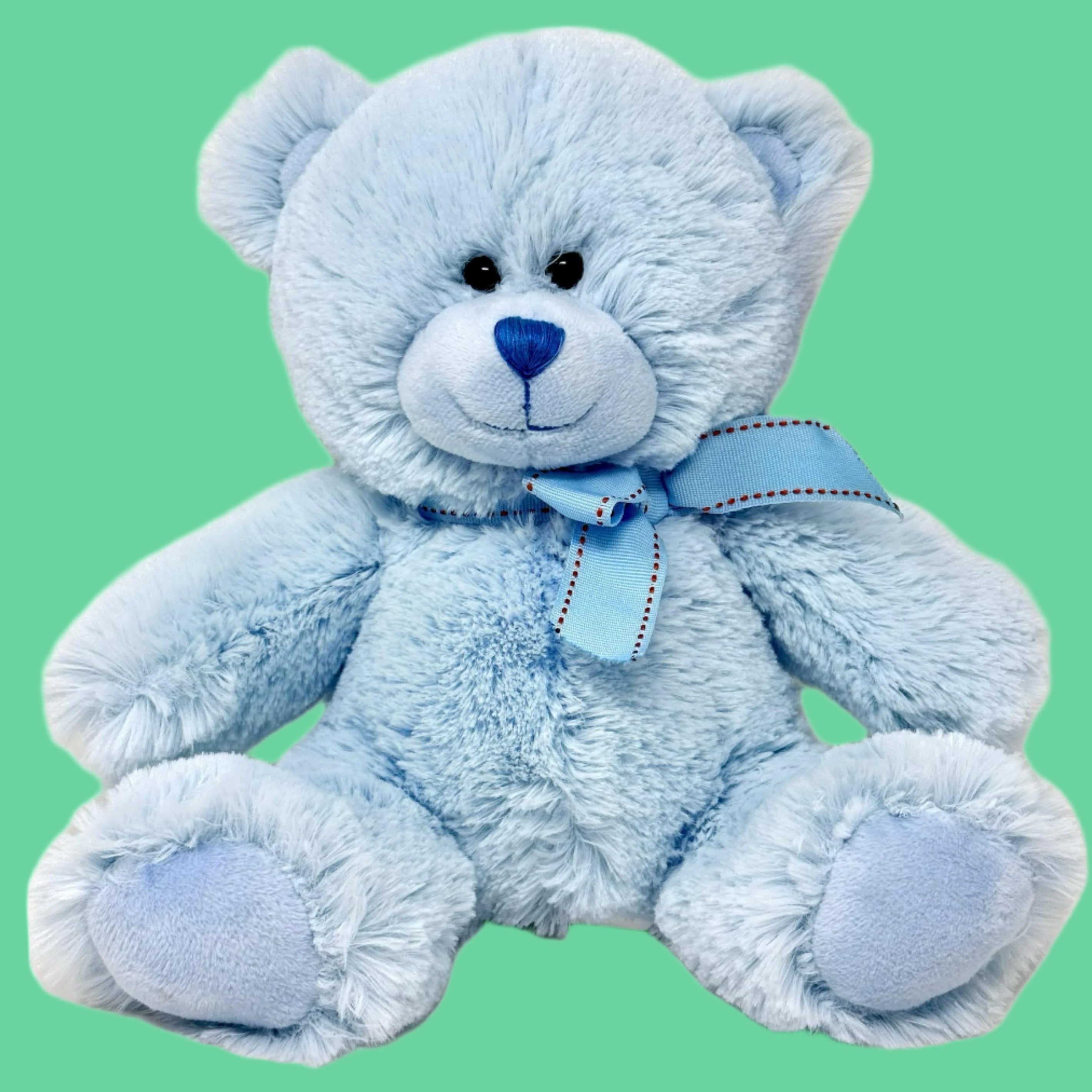 A plush blue teddy bear with a blue ribbon around its neck.